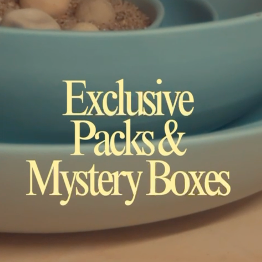 Text 'Exclusive Packs & Mystery Boxes' over a blurred background with bowls.
