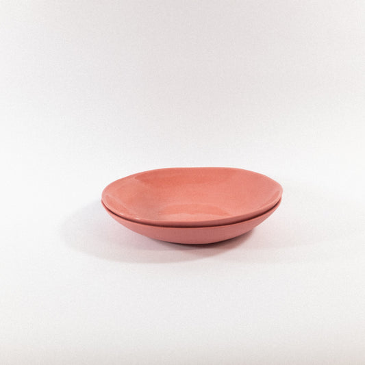 Handmade blush pasta plates on a white background