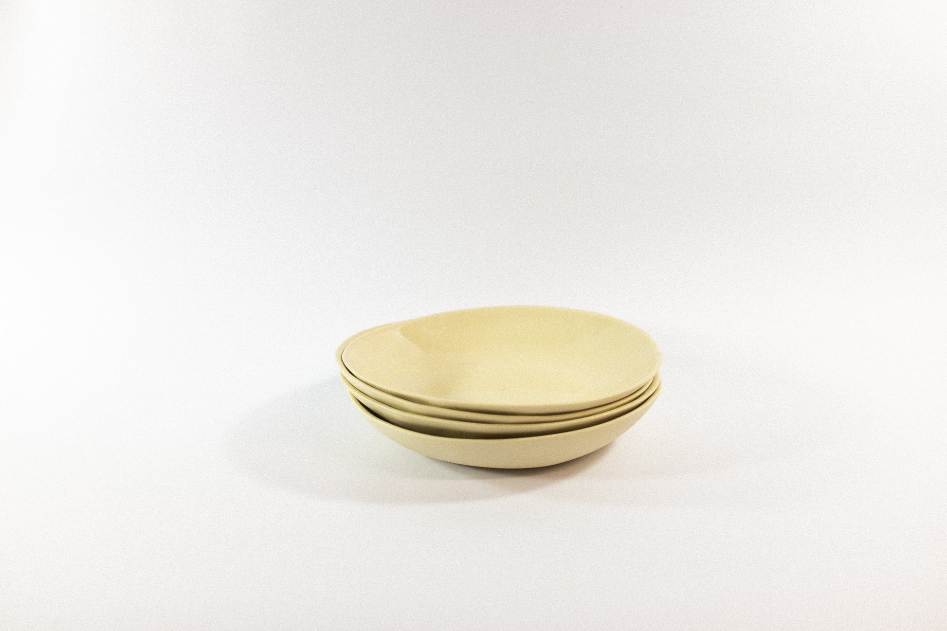 Handmade cream pasta plates on a white background