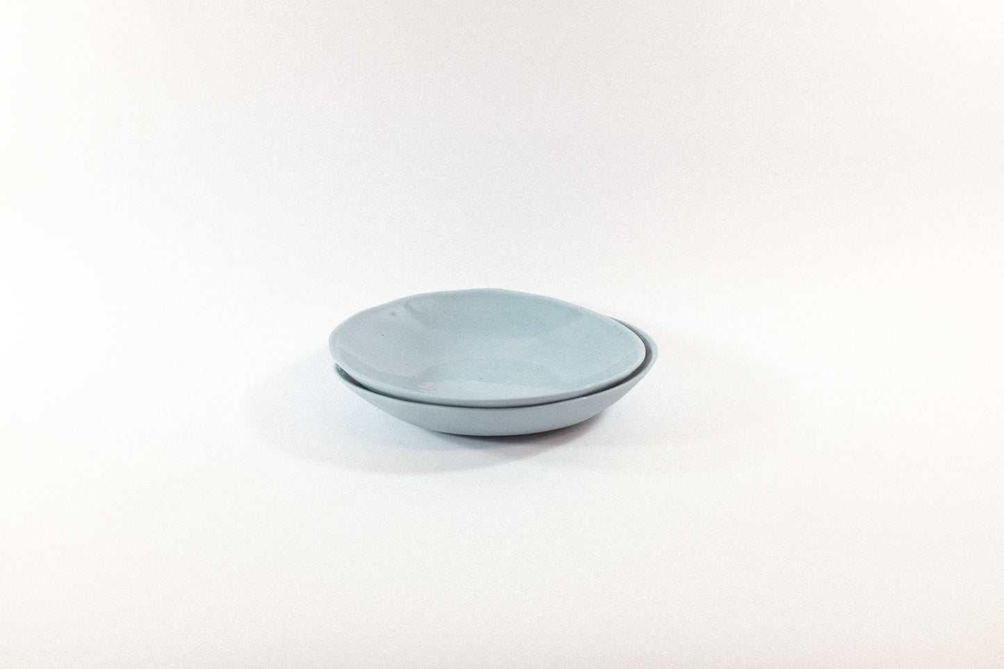 Handmade two lavender pasta plates on a white background