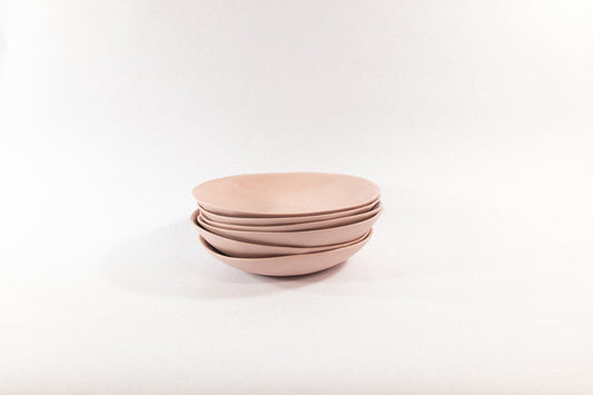 Handmade powder pasta plates on a white background