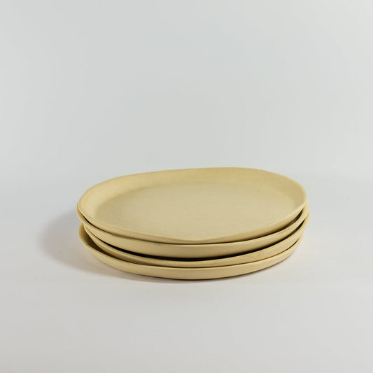 Handmade small porcelain dinner plates on a white background
