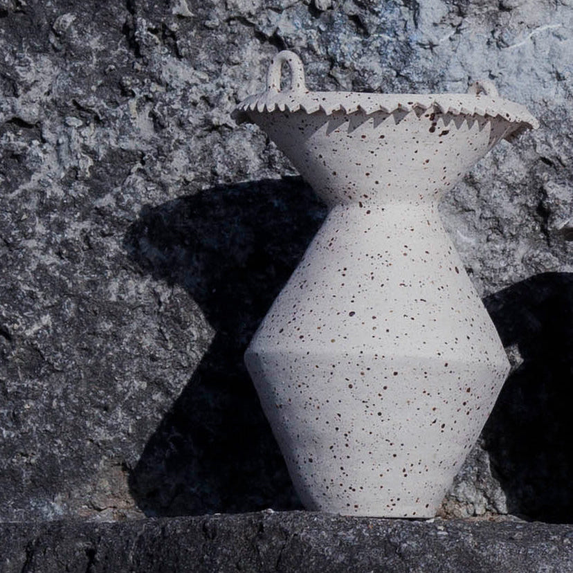 Handmade big stoneware vase with textured surface on a gray stone background