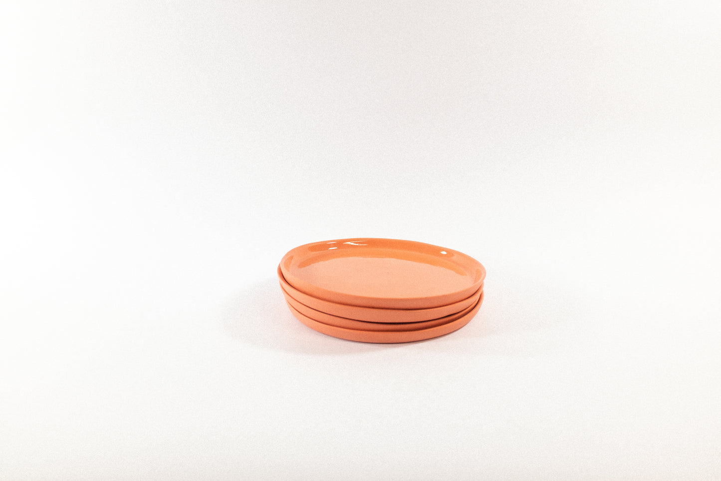 Handmade strong salmon dessert plates on a white background