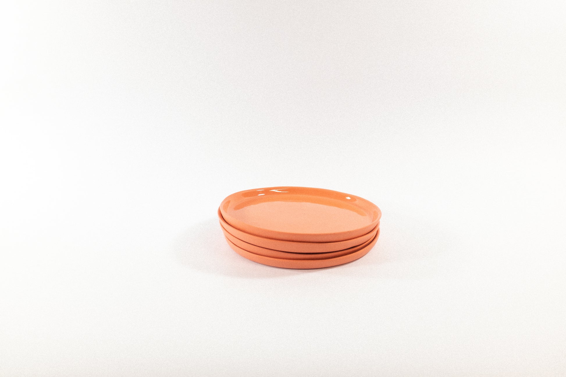 Handmade strong salmon dessert plates on a white background
