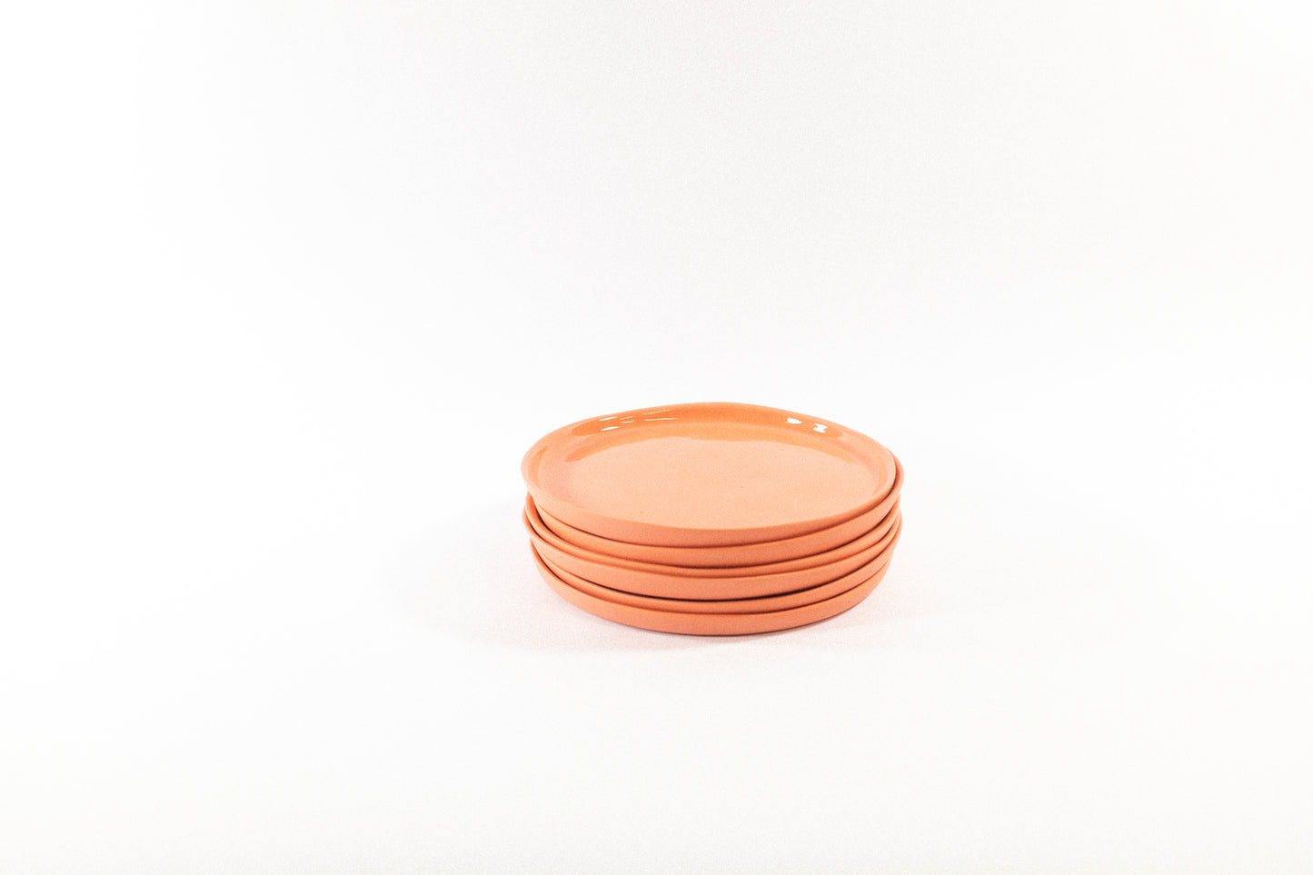 Handmade strong salmon dessert plates on a white background