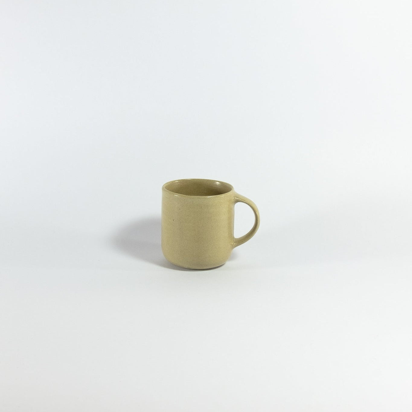 Green ceramic mug on a white background